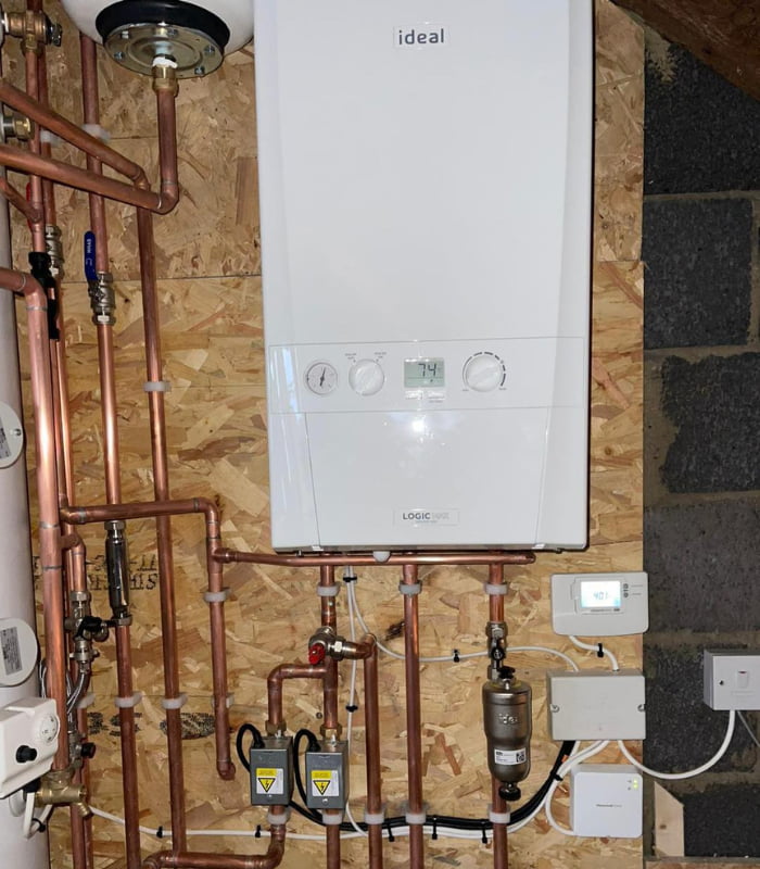 A newly-replaced boiler installed into a wood panel wall
